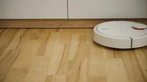 White robot vacuum cleaner in the interior at home Stock Footage 150230071