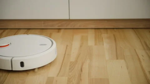 White robot vacuum cleaner in the interior at home Stock Footage 150230076