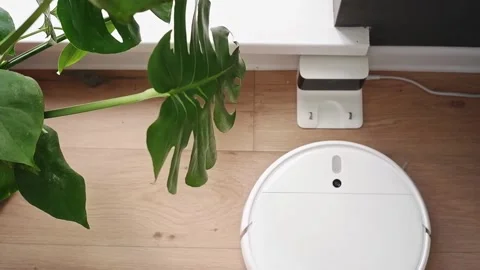 White robot vacuum cleaner returning to charging station Video stock 303353840