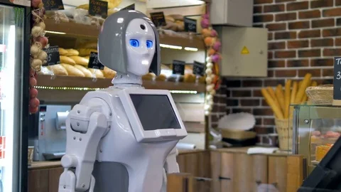 A white robot works at a bakery counter. Stock Footage 80647927