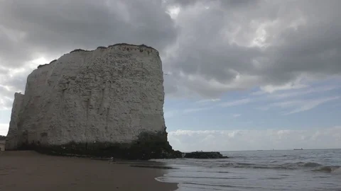 White rock and the sea under fluffy clouds. Stock Footage 77109401
