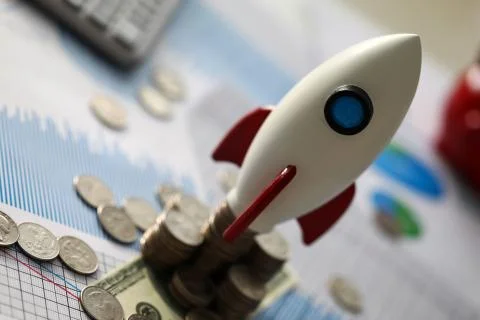 White rocket on coins Stock Photos