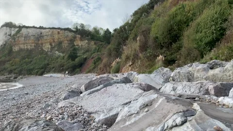 White rocks on a beach with waves crashing in the background. Stock-Footage 219890774