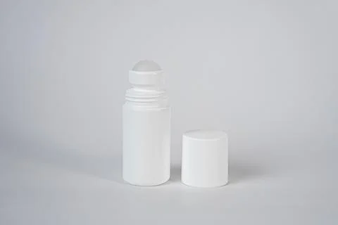 White roll-on deodorant bottle on minimal grey background Stock Photos