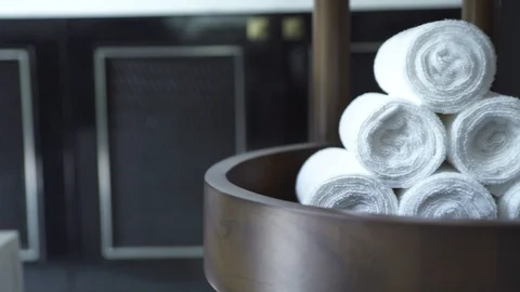 White rolled towel folded in stack in modern spa salon on dark background. White Stock Footage 106488307