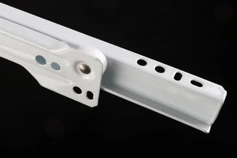 White roller guide used in carpentry. Furniture accessories on a workbench. Stock Photos