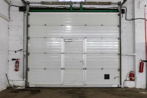 White rolling shutter at warehouse interior Stock Photos