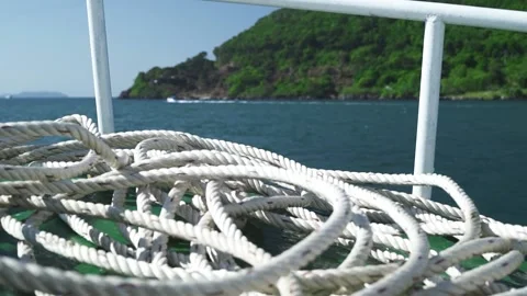 A white rope spread on green deck of a boat traveling in the blue sea on summer. Video stock 132797806