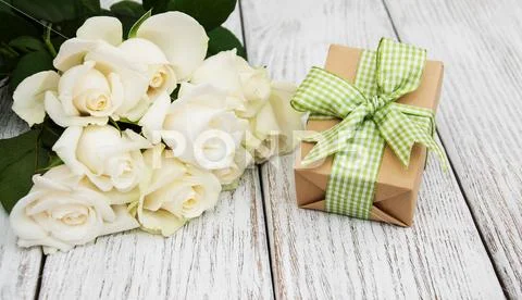 White roses and gift box Stock Photos