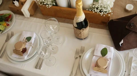 White roses with greenery stand on the festive served dinner table, close-up Stock Footage 65957320