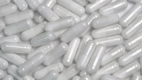 White rotating capsules background texture Stock Footage 155700142