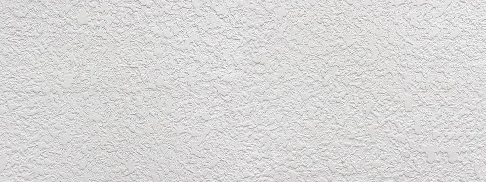 White rough plaster wall texture providing detailed background Stock Photos