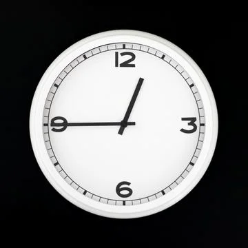 White round analog wall clock isolated on black background. Stock Photos