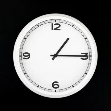 White round analog wall clock isolated on black background. Stock Photos