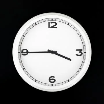 White round analog wall clock isolated on black background. Stock Photos