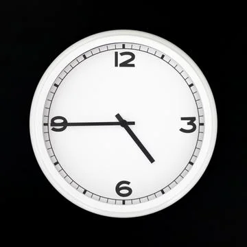 White round analog wall clock isolated on black background. Stock Photos