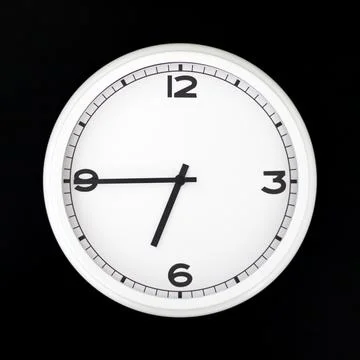 White round analog wall clock isolated on black background. Stock Photos