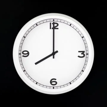White round analog wall clock isolated on black background. Stock Photos