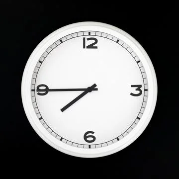 White round analog wall clock isolated on black background. Stock Photos