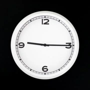 White round analog wall clock isolated on black background. Stock Photos