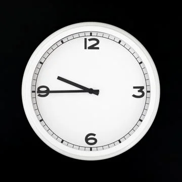 White round analog wall clock isolated on black background. Stock Photos
