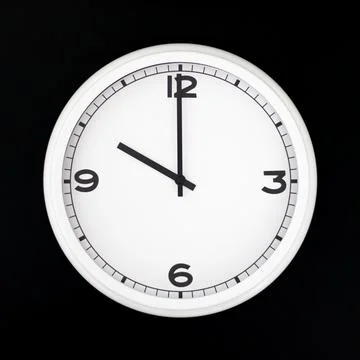 White round analog wall clock isolated on black background. Stock Photos