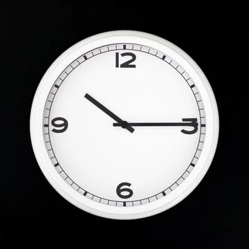 White round analog wall clock isolated on black background. Stock Photos