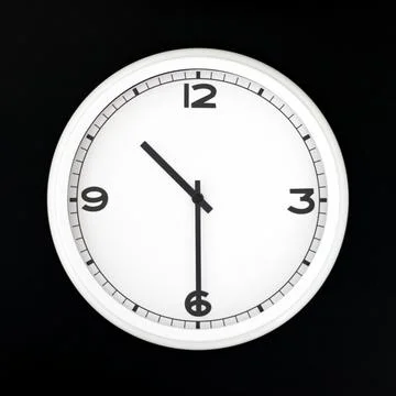 White round analog wall clock isolated on black background. Stock Photos
