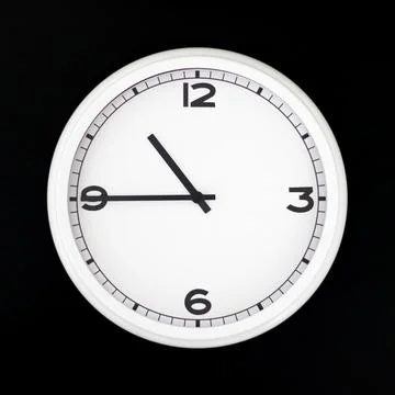 White round analog wall clock isolated on black background. Stock Photos