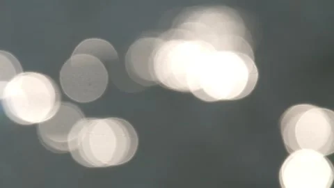 White round bokeh of sunlight reflection on the surface of the river water Stock Footage 321267561
