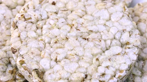 White round crispy puffed rice cakes texture circle rotation close up Stock Footage 268862246