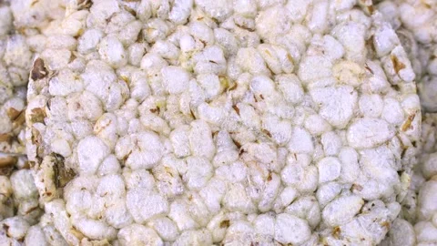 White round crispy puffed rice cakes texture circle rotation close up Stock Footage 271180645
