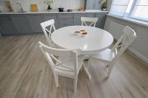 White round dining table and chairs for four Stock Photos