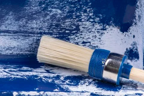 White round painter brush in an old blue painter container Stock Photos
