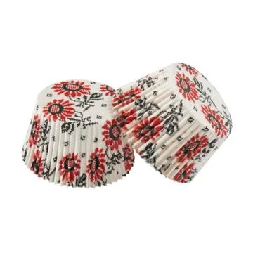 White round paper baking forms for muffins and cupcakes with flowers pattern Foto stock