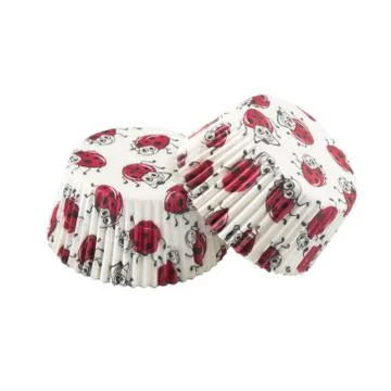 White round paper baking forms for muffins and cupcakes with ladybug pattern Stock Photos