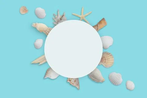 White round paper surrounded by shells. Summer travel background Stock Photos