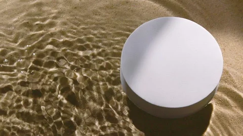 White round podium on sand and water wave, ripple, splash and tree leaf shadow Vídeo Stock 254458559