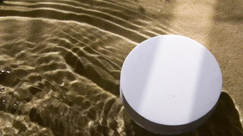 White round podium on sand and water wave, ripple, splash and tree leaf shadow Vídeo Stock 259935383
