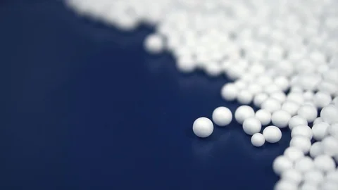 White round polystyrene packaging material drop in slow motion Stock Footage 119767519
