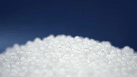 White round polystyrene packaging material drop in slow motion Stock Footage 119767874