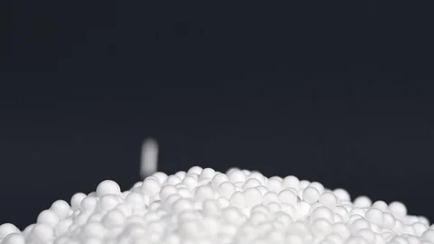 White round polystyrene packaging material drop in slow motion Stock Footage 119767960