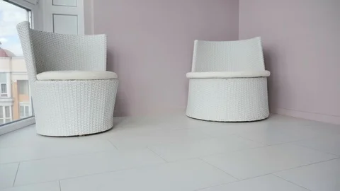 White round robot vacuum machine removing dirt on tile floor of modern balcony. Stock Footage 117254855