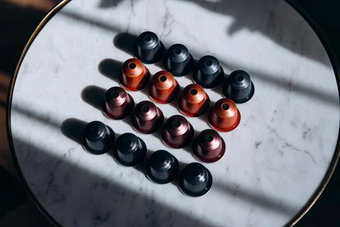White round table with four rows of coffee capsules Stock Photos