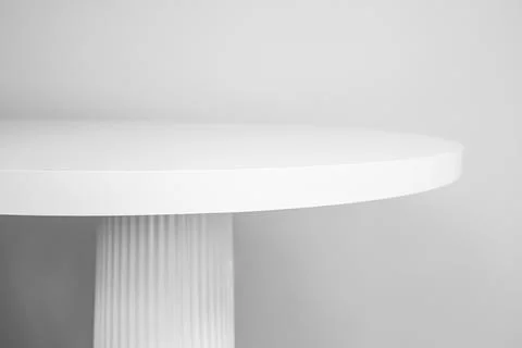 White round table top with column leg, side view on gray wall background, m.. Stock Photos