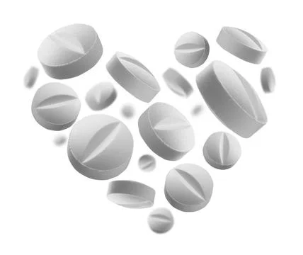 White round tablets in the shape of a heart on a white background White ro... Stock Photos