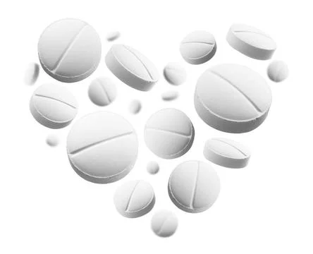 White round tablets in the shape of a heart on a white background White ro... Stock Photos