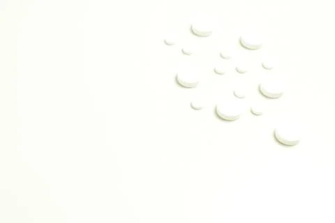 White round tablets on a white background Stock Photos
