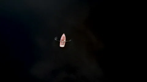 White rowboat sailing on a large lake Stock Footage 164501553