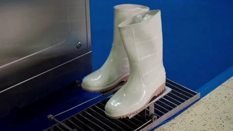 White rubber boots driven on the spot by a motorized mechanical device. Stock Footage 162985332